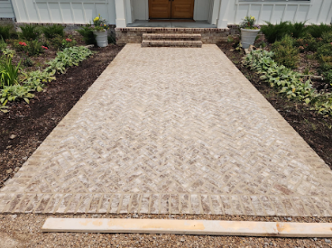 Herringbone paver walkway leading to front entry