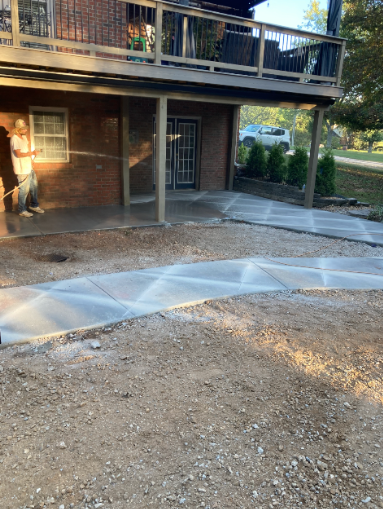 Concrete walkway and patio under an elevated deck